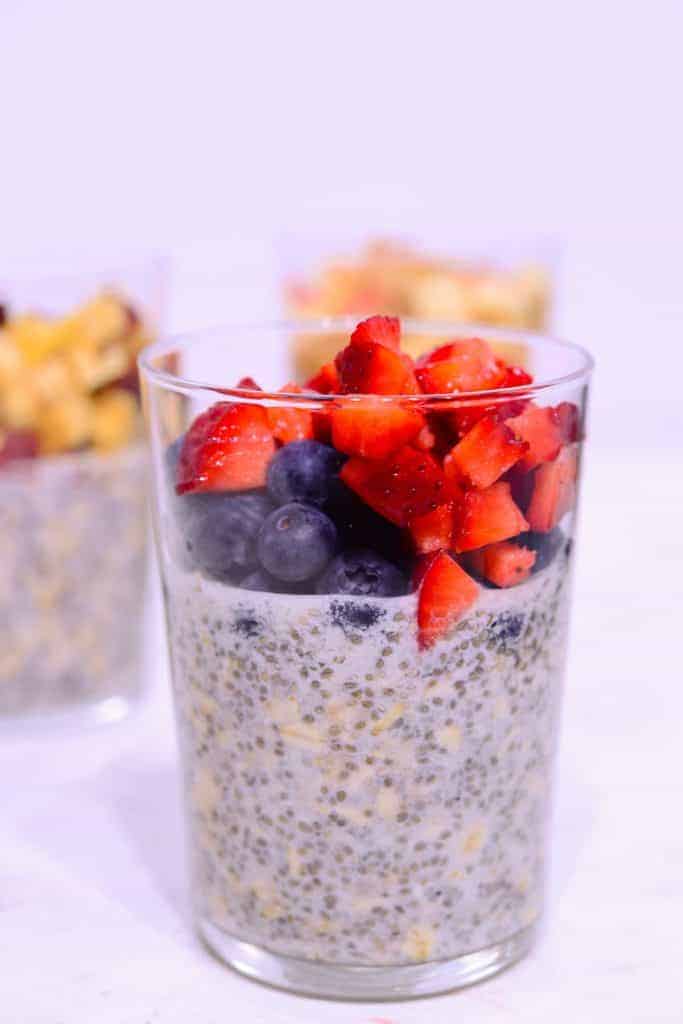 blueberries and strawberries on top of high protein overnight oats. 