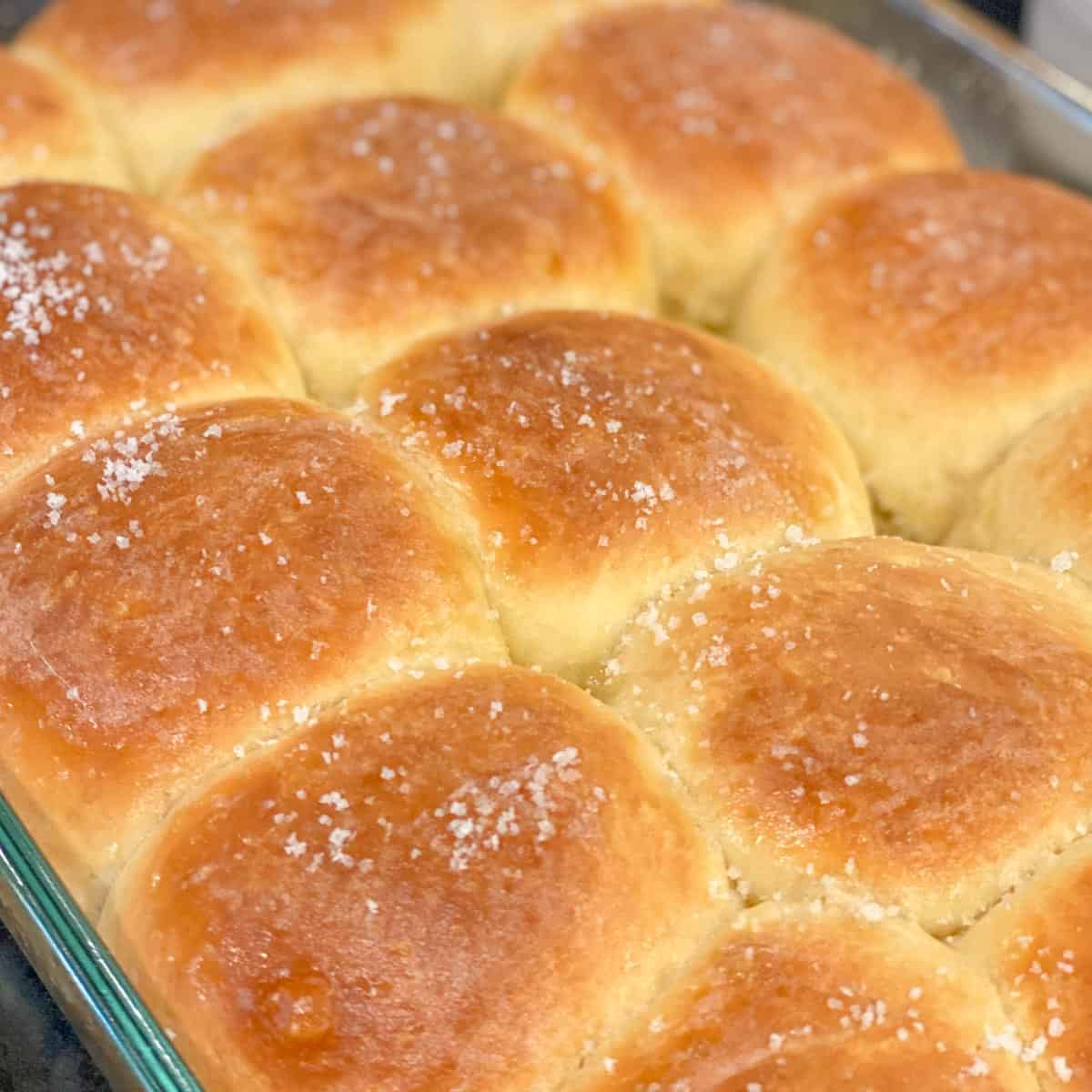 dinner rolls recipe topped with butter and salt