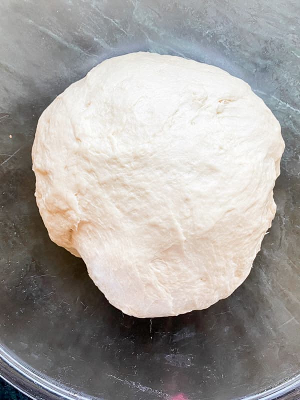 French bread dough in an oiled bowl, first proof step | foodology geek