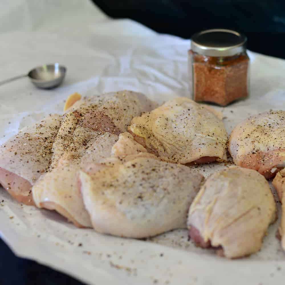 seasoned chicken thighs. salt and pepper is added right before baking.