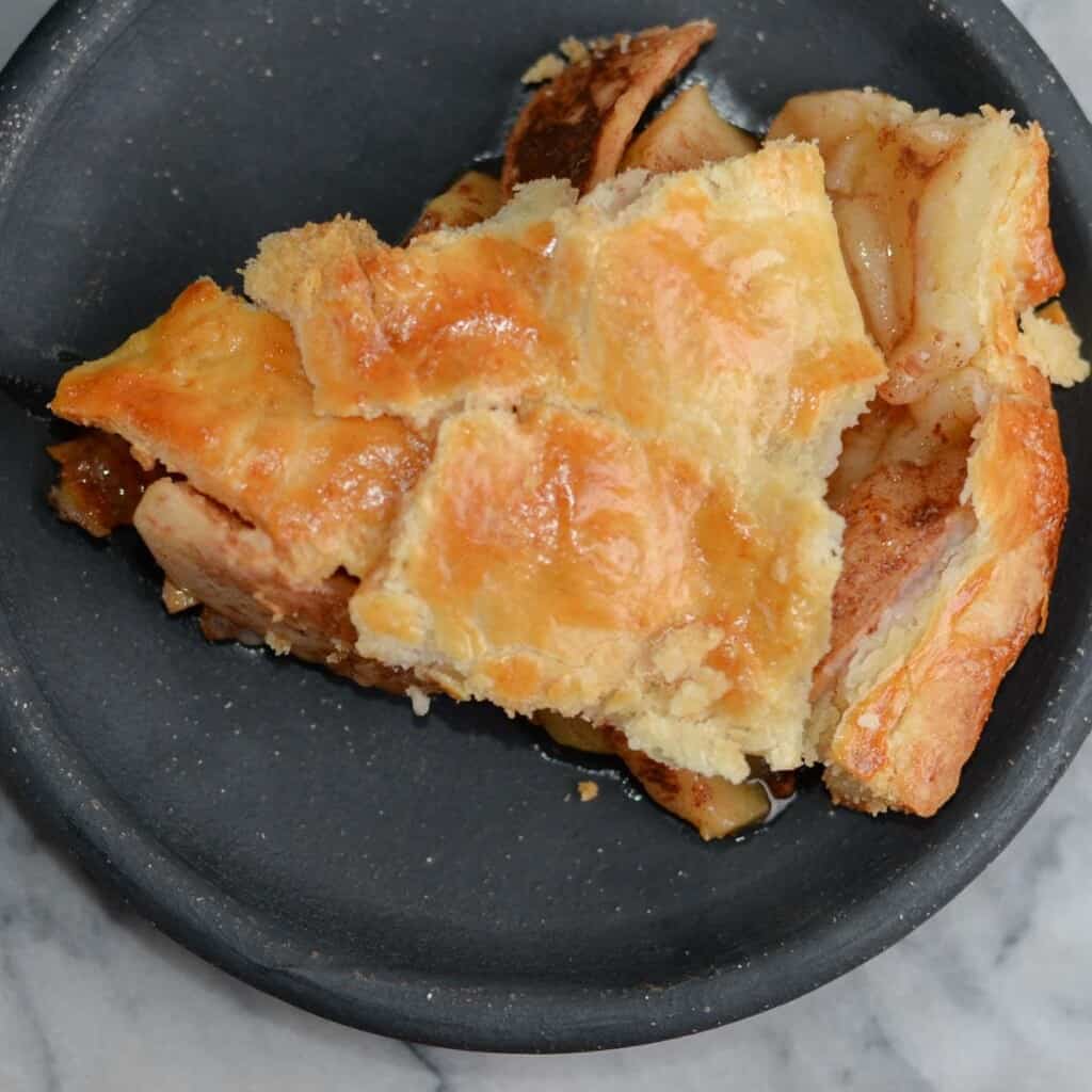 slice of apple pie with flaky pie crust