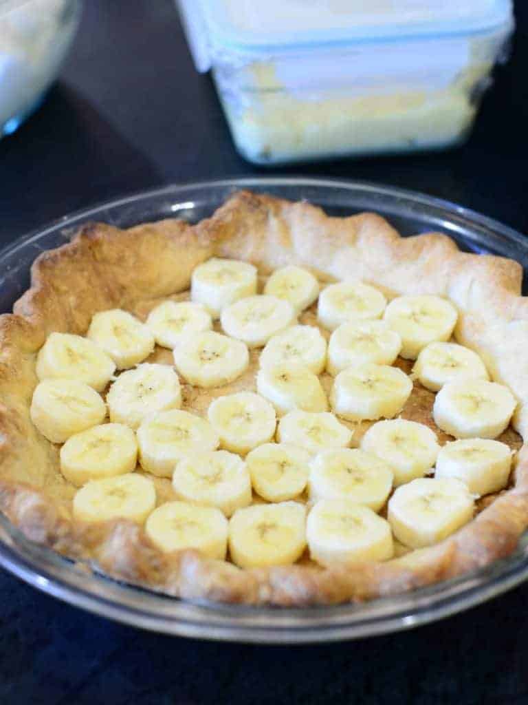 a blind baked pie crust with a layer of sliced bananas. 