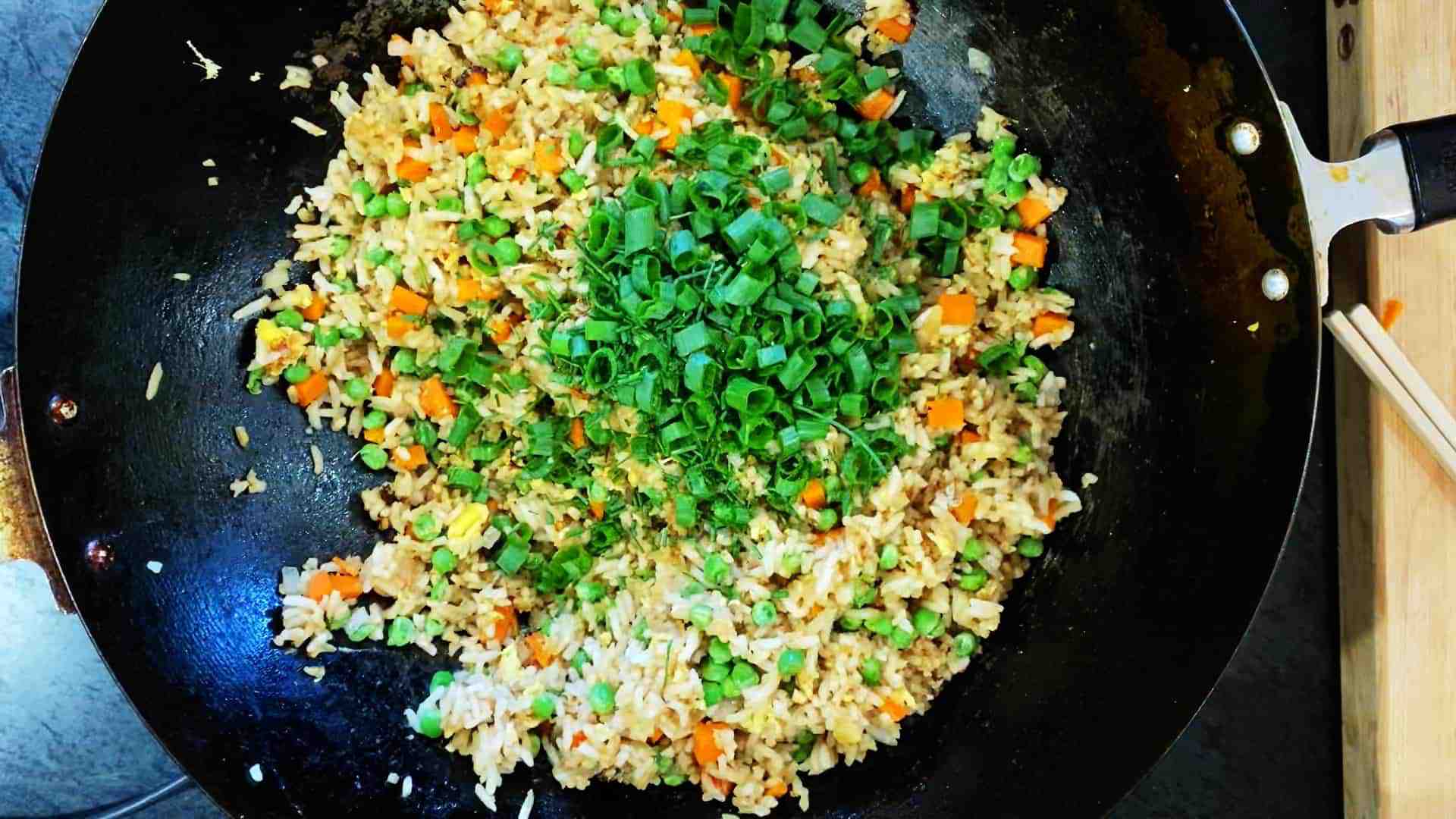 vegan fried rice with green onions on top