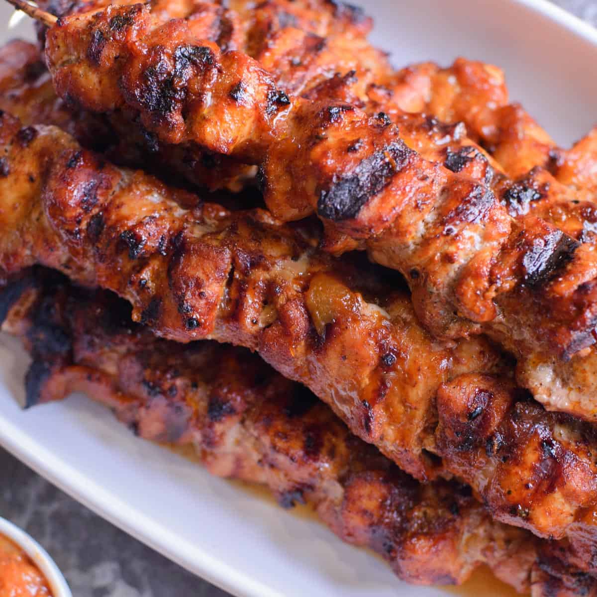 a stack of bbq pork kebabs with peach bourbon bbq sauce.