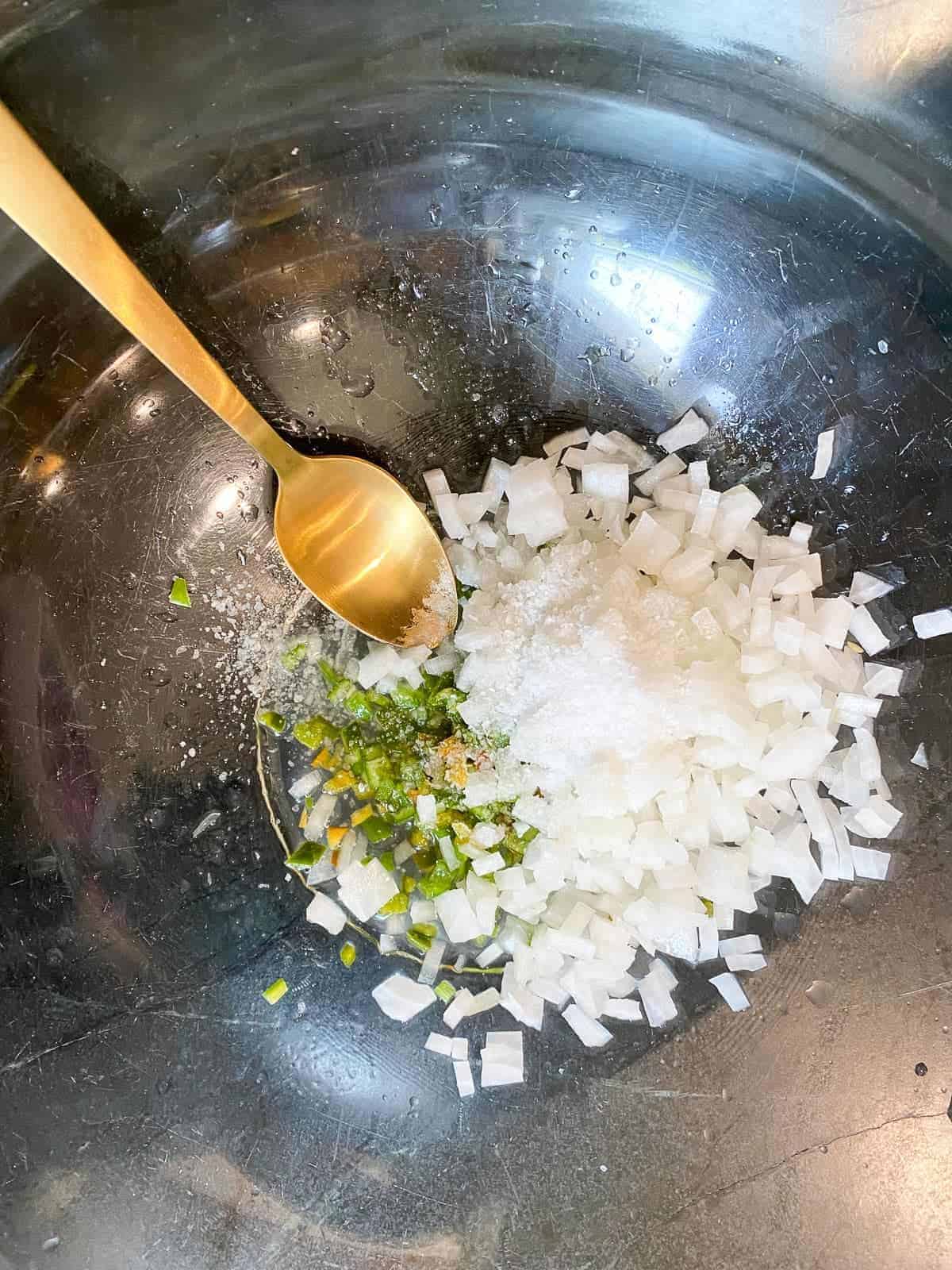 serrano peppers and white onions finely diced, making pico de gallo