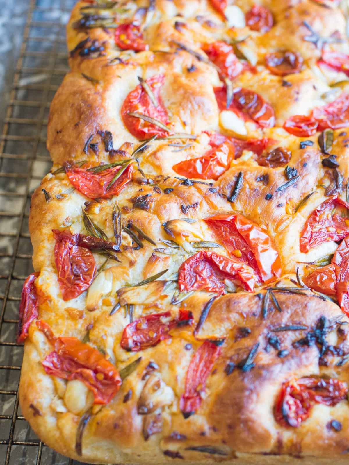 Fresh focaccia bread is easy to make and makes a fantastic appetizer. This focaccia bread recipe is easy. Keep it simple topped with rosemary or try this garlic, rosemary, and tomato topping.