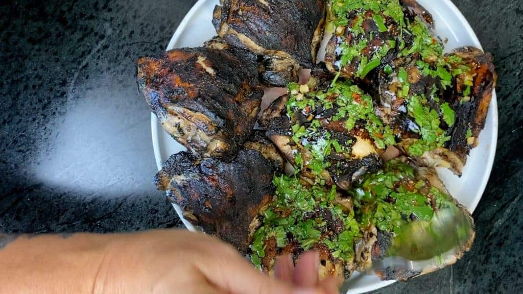 Add the chimichurri sauce to the grilled chicken. 