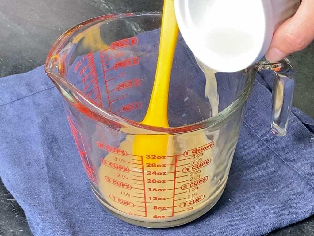 Adding lemon juice to the tahini to make tahini dressing