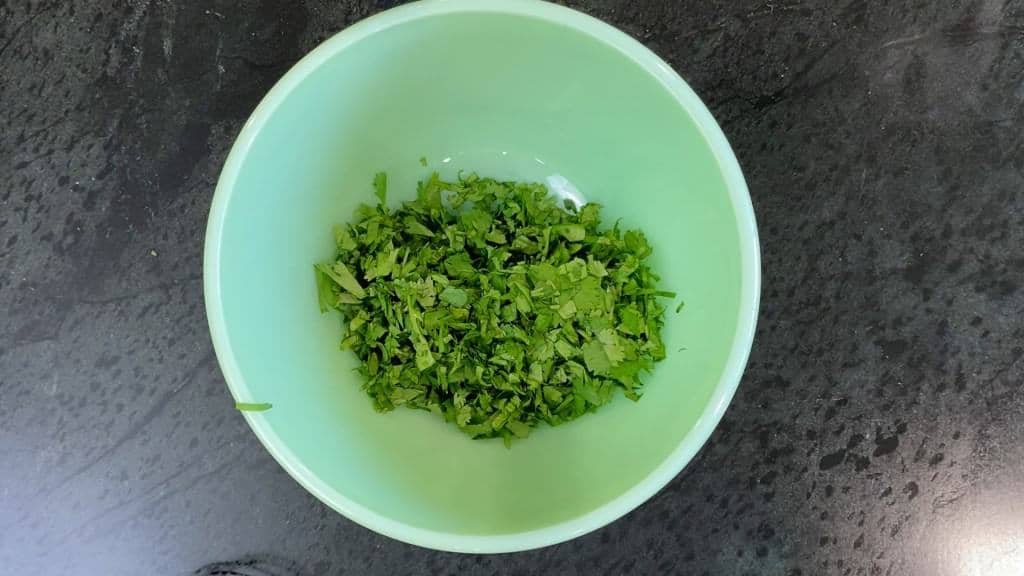 diced parsley in a greenish bowl - chimichurri recipe