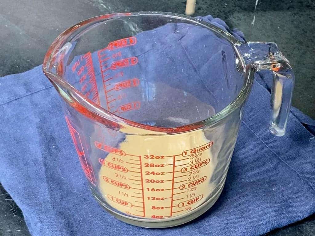 Measuring cup with 1/3 cup of tahini in it