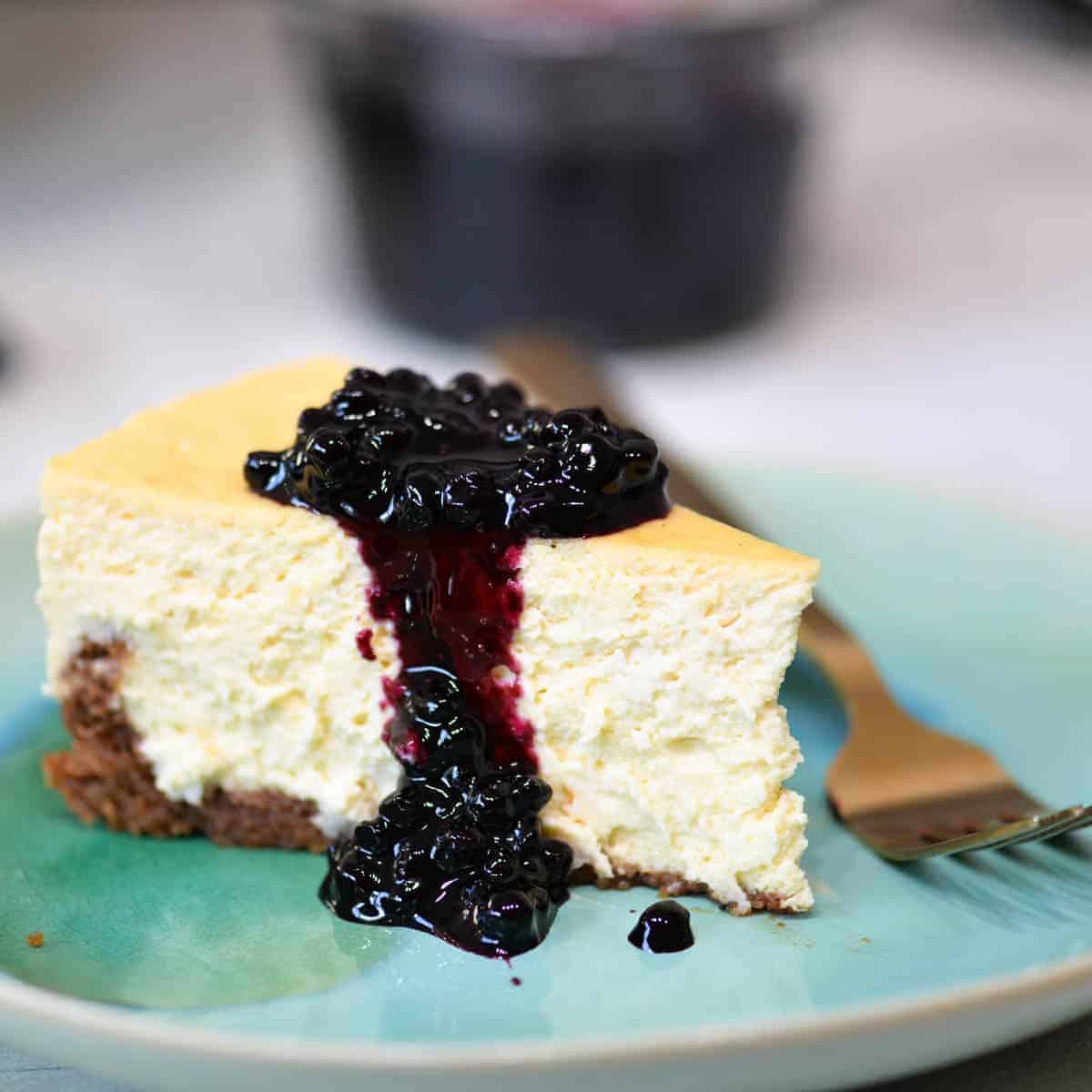 blueberry cheesecake on an aqua plate