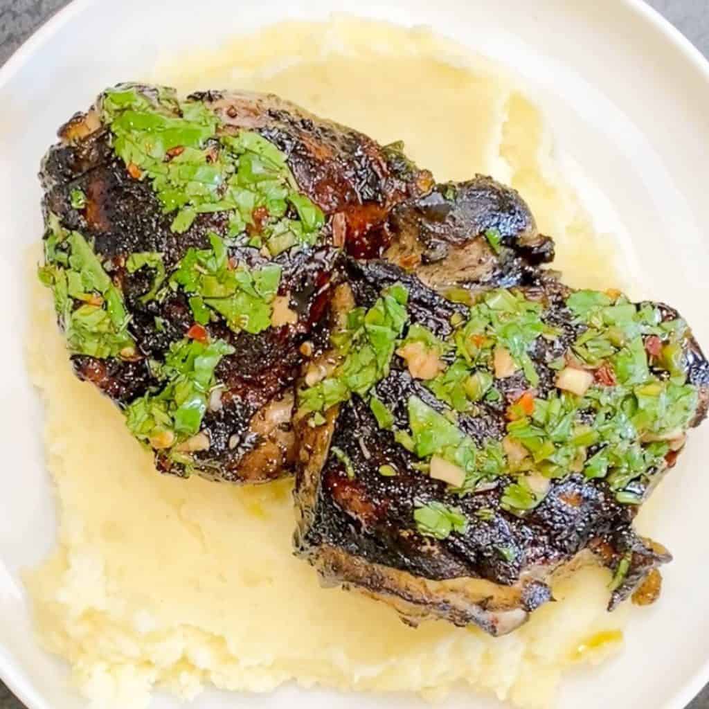 Chimichurri chicken served on a bed of goat cheese mashed potatoes. Smothered in Chimichurri Sauce. 