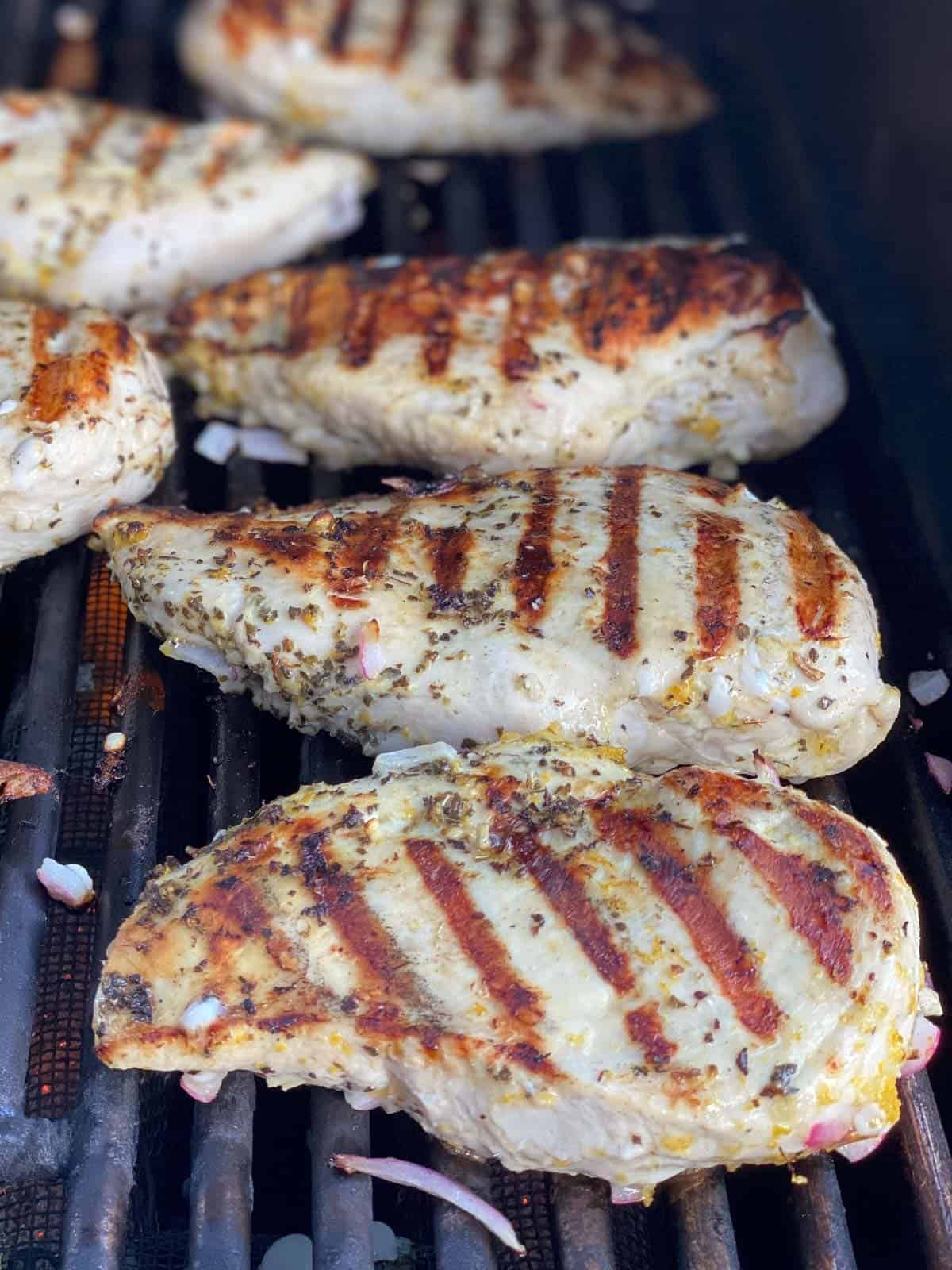 Marinated chicken grilling on the grill.