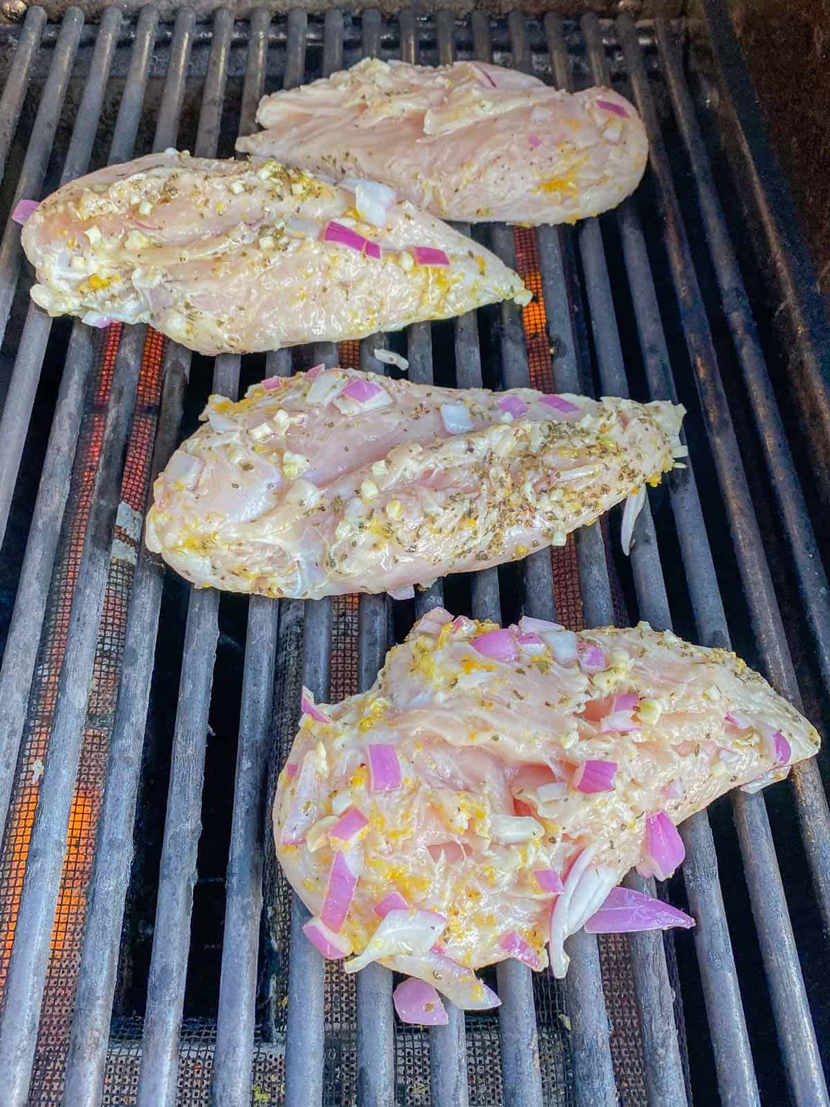 marinated chicken on the grill at the beginning of cooking