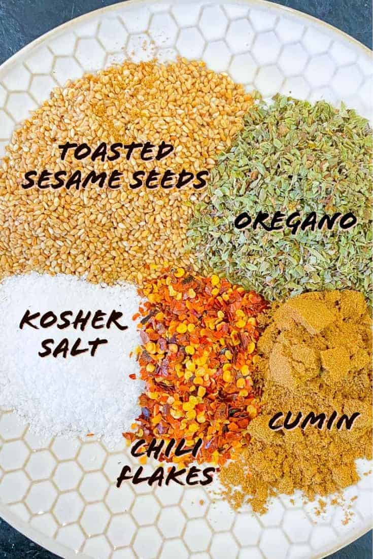 Labeled ingredients used to make Mediterranean Seasoning blend on a plate.