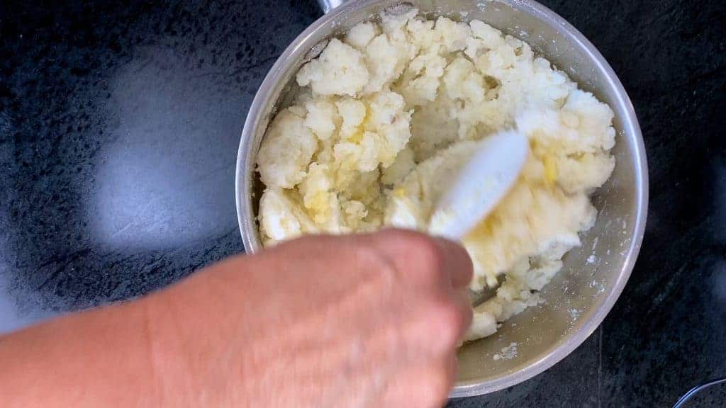 Add the broth and then mix together to combine. 