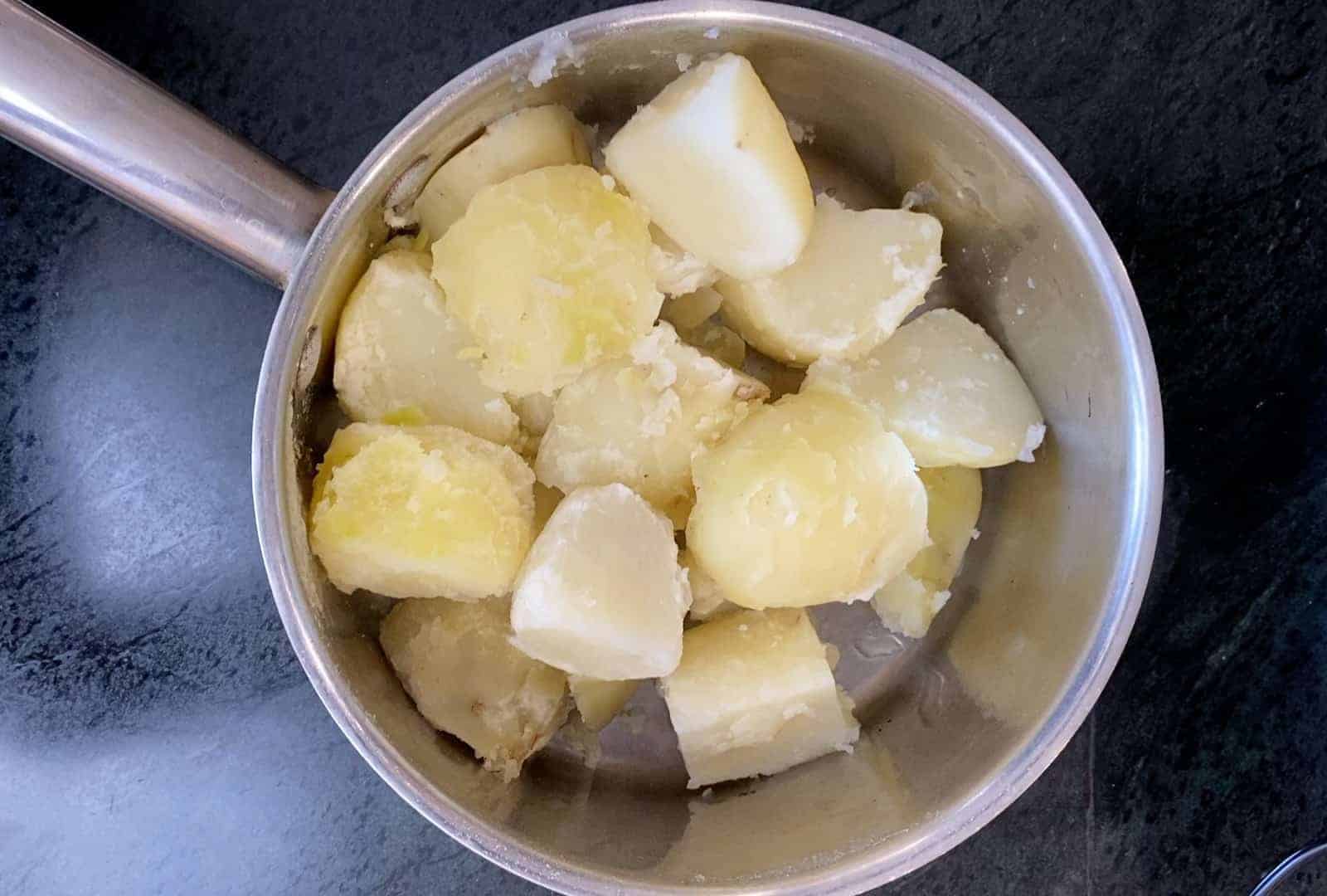 quartered potatoes boiled in a pot