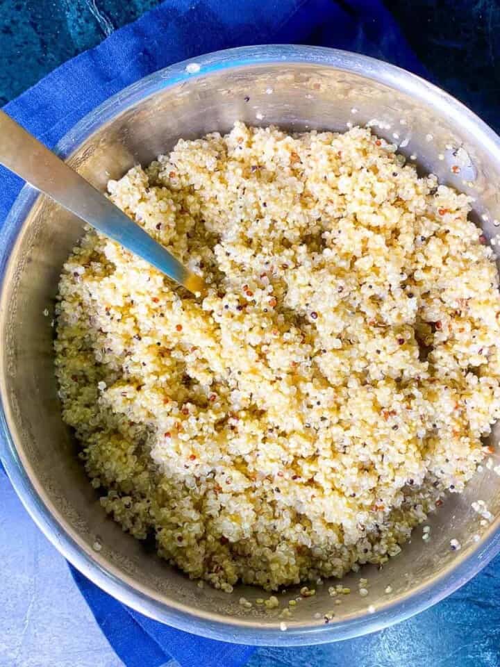 quinoa in a pan with a fork in for fluffing