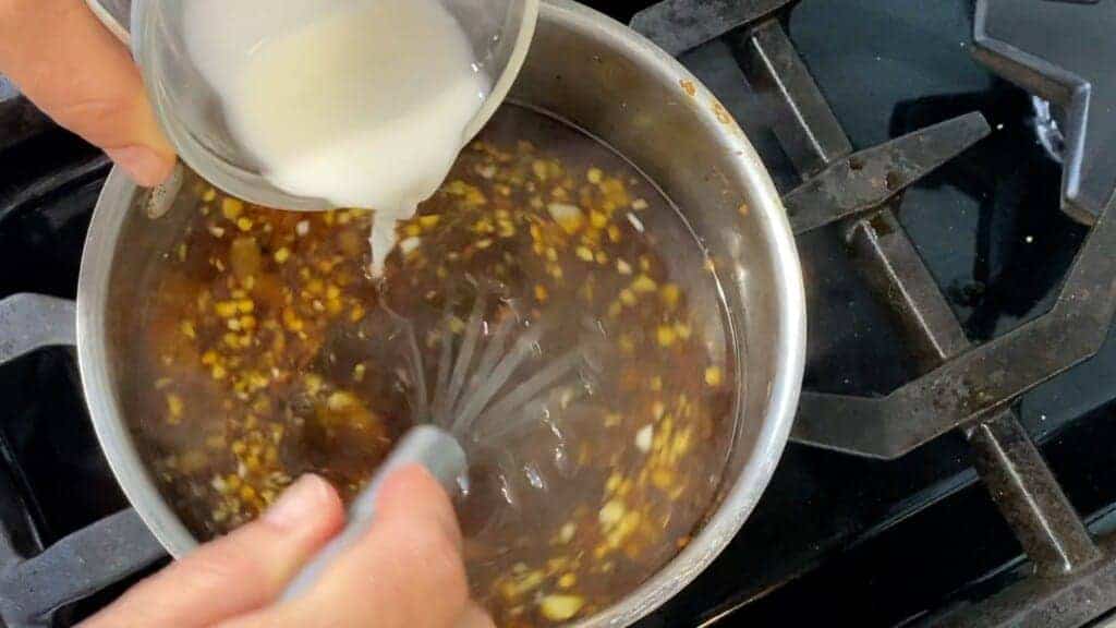 addin cornstarch slurry to simmering teriyaki sauce