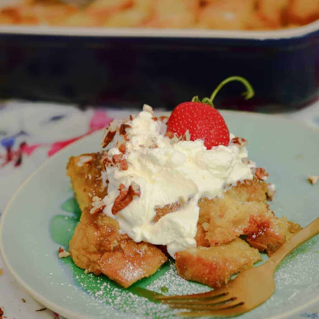 baked french toast casserole with whipped creme and strawberries