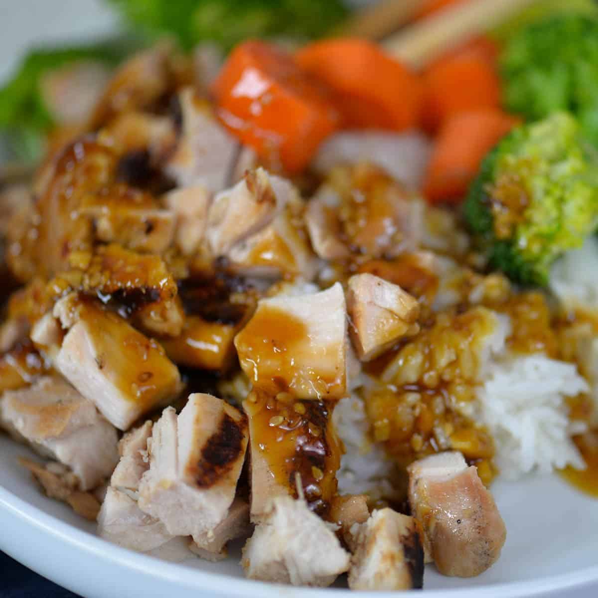 grilled teriyaki chicken bowl with grilled chicken thighs, steamed rice, and veggies