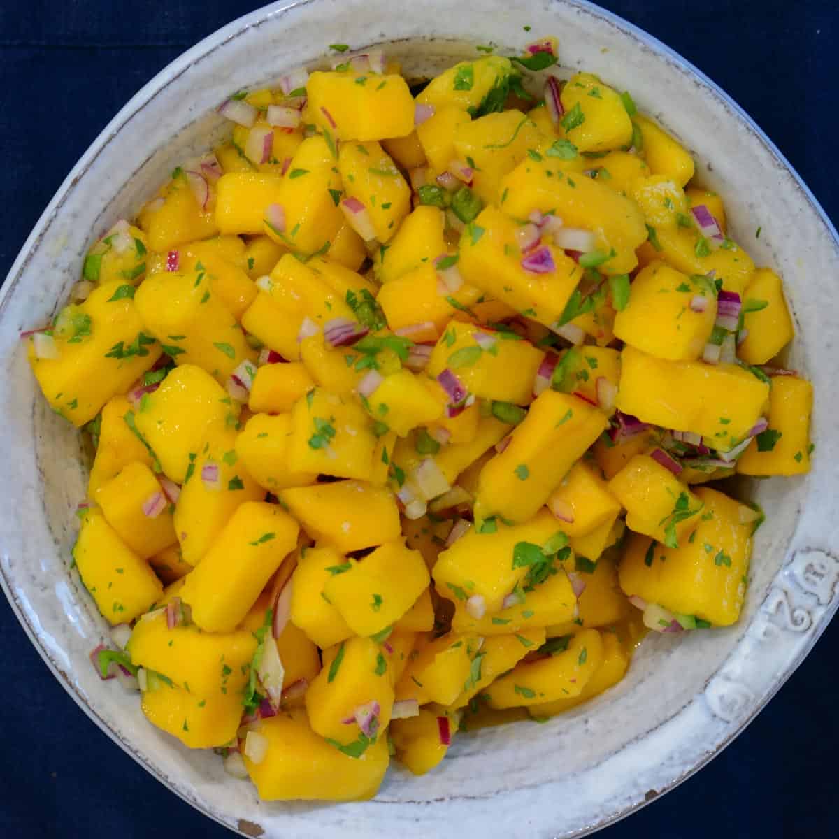 mango salsa recipe in a white bowl