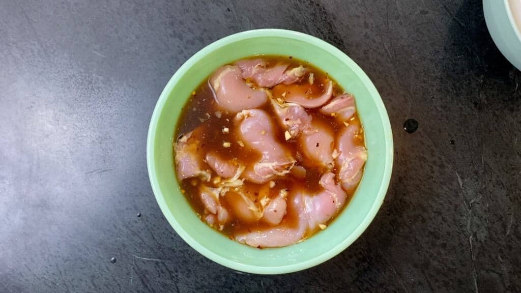 teriyaki chicken thighs in a green bowl