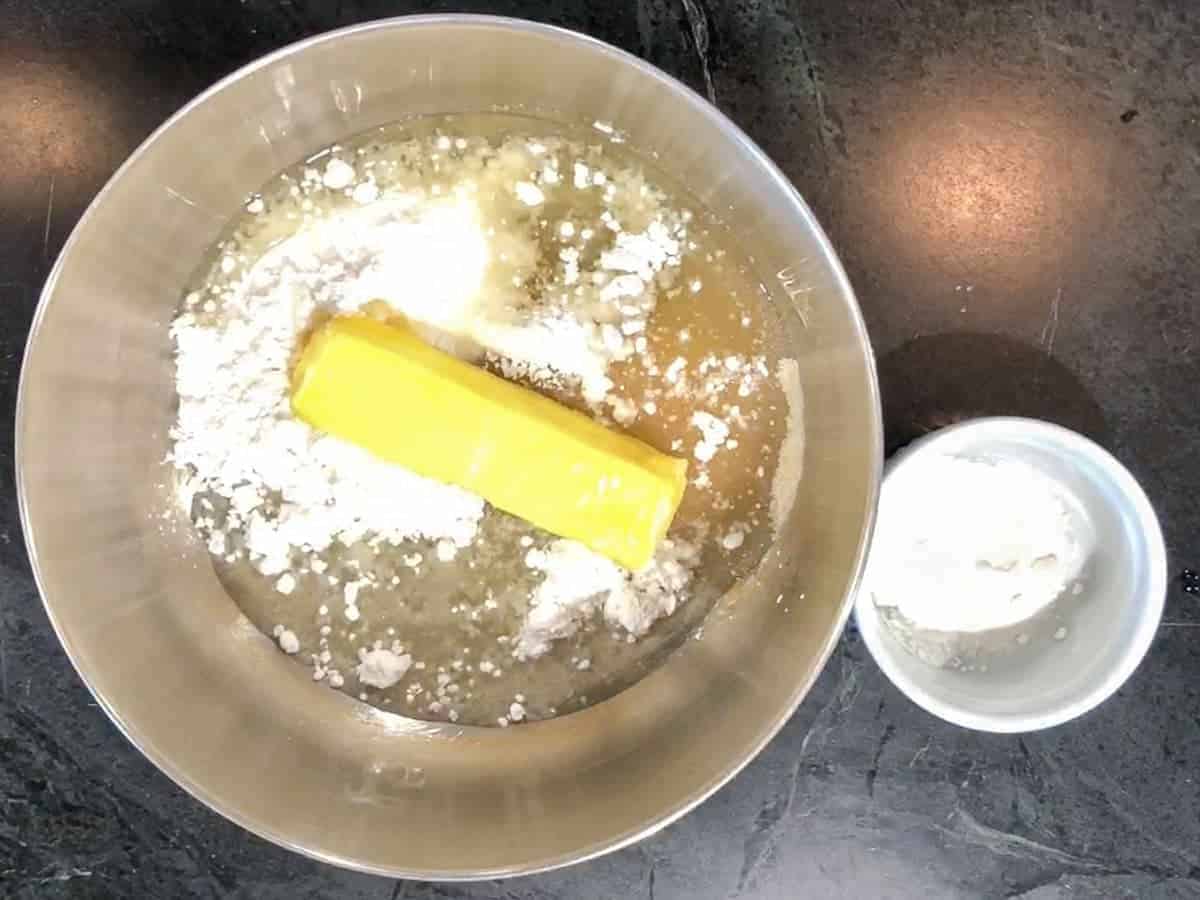 adding a half cup of butter to the sugar cookie dough