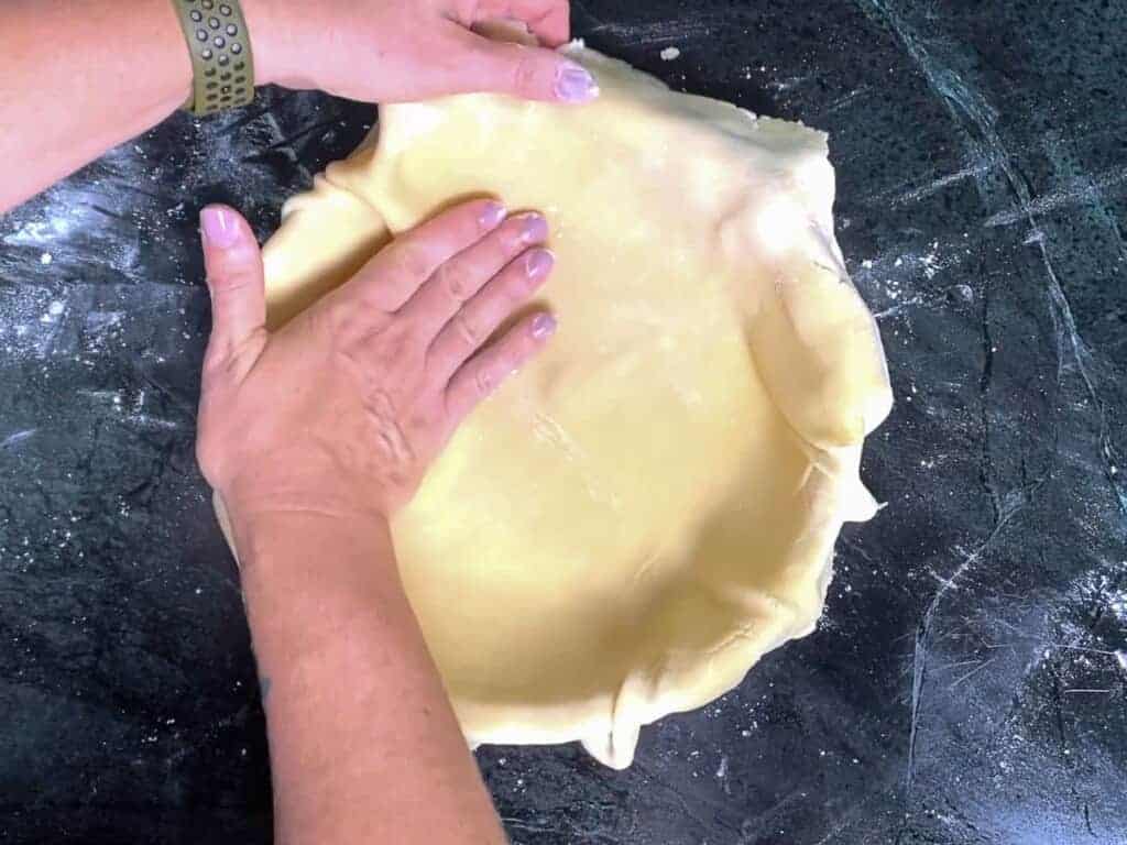 gently press the pie dough into the pie dish