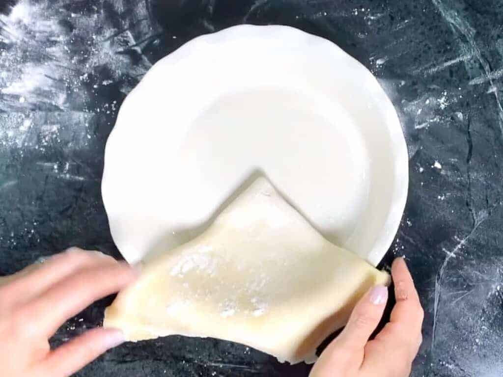 place the pie dough into the pie dish