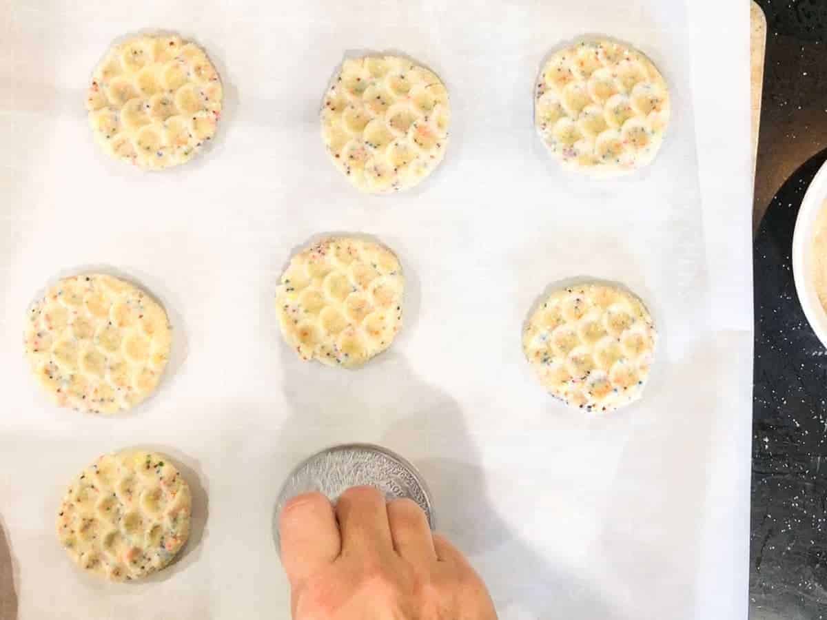 press the cookies using a cookie scoop