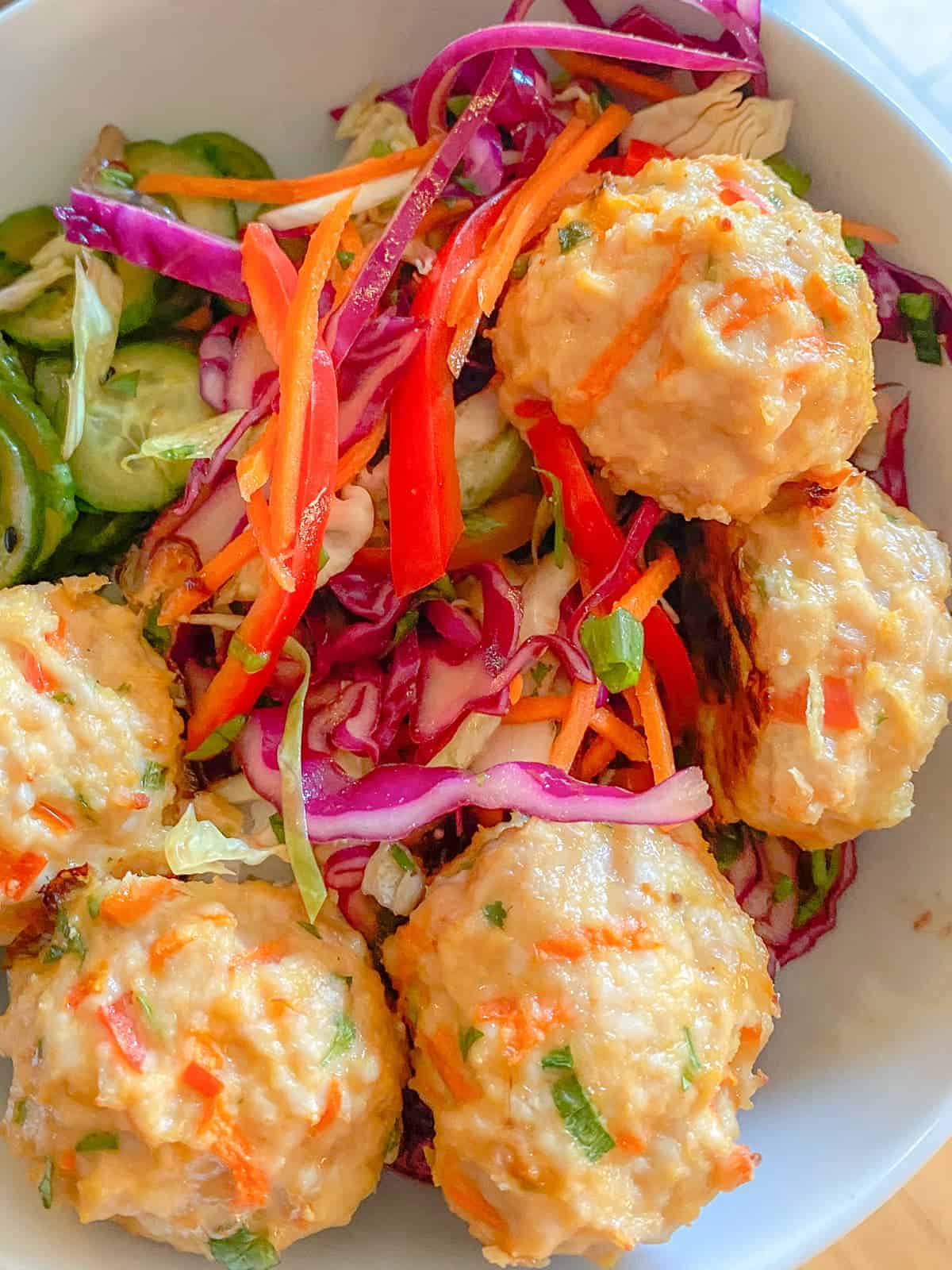 Asian Chicken Meatballs with Asian Slaw in a bowl