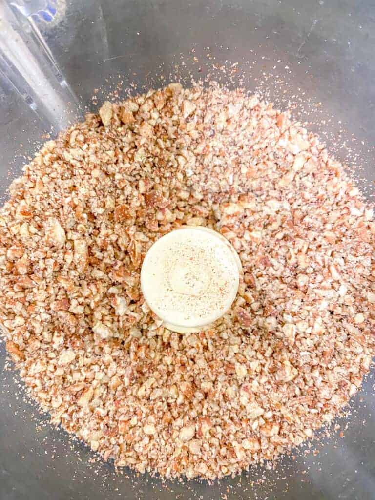 chopped pecans in a food processor bowl