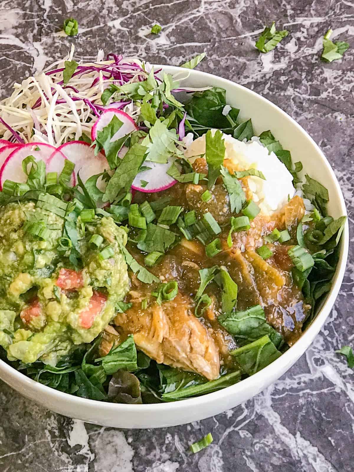 green chicken chili bowl with rice and guacamole