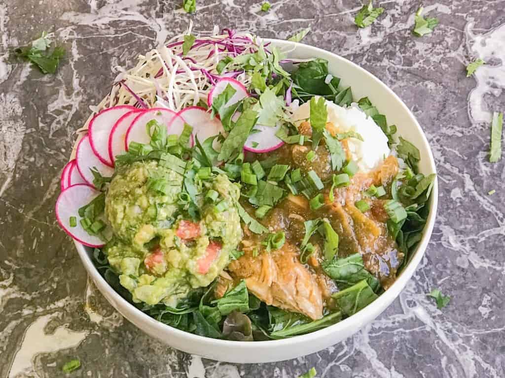 green chicken chili served with rice and guacamole