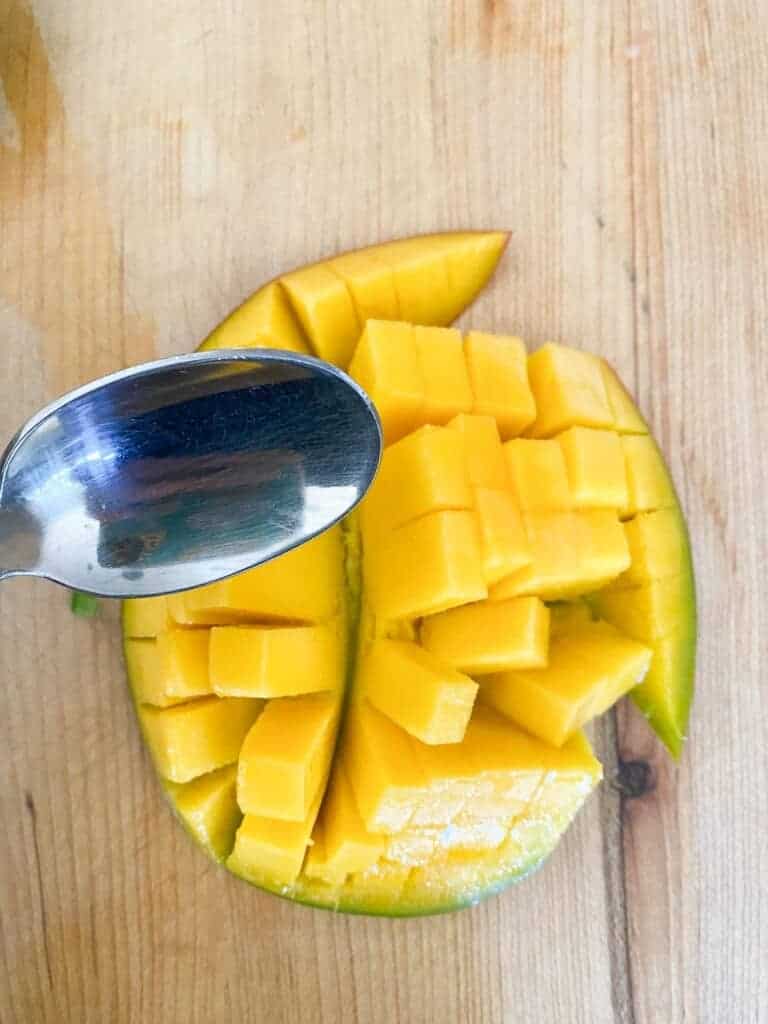 use a spoon to remove the fruit from the skin