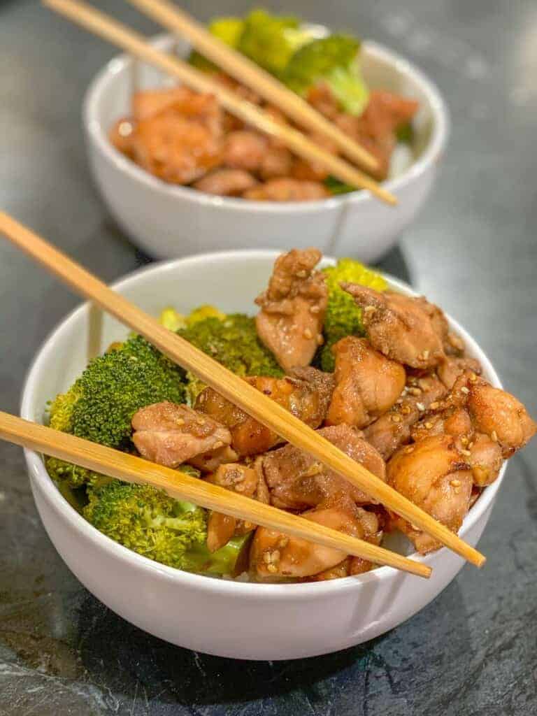 two bowls of easy chicken and broccoli with chopsticks