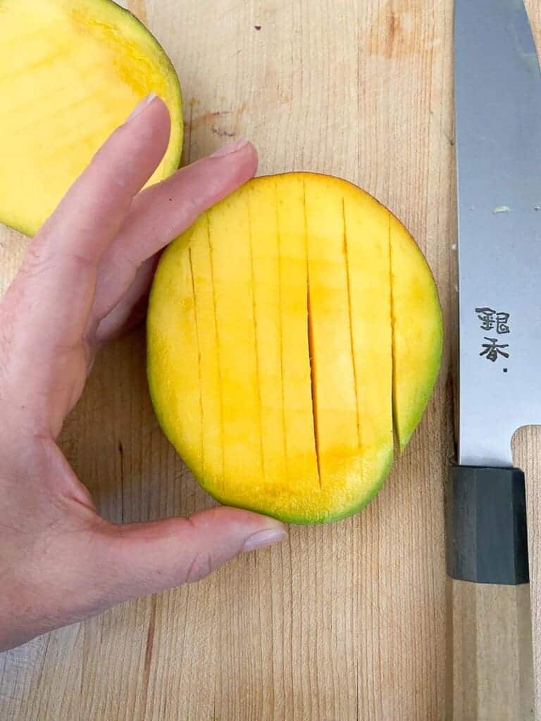 use a knife to slice strips into the mango