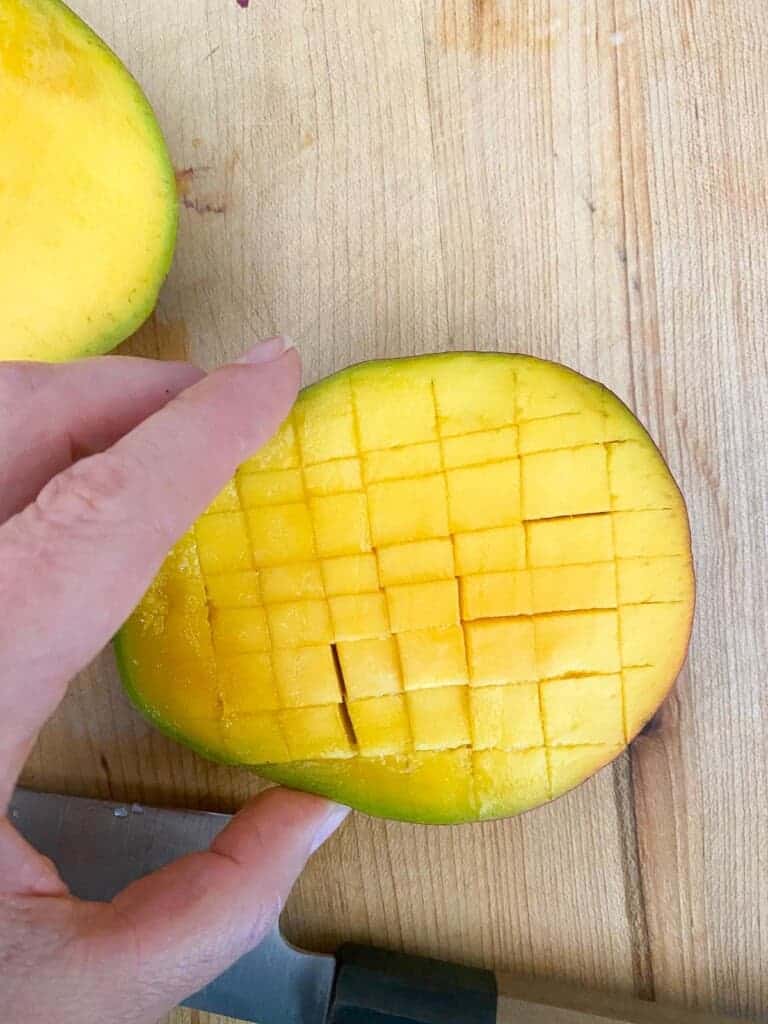 turn the mango and cut strips in the opposite direction