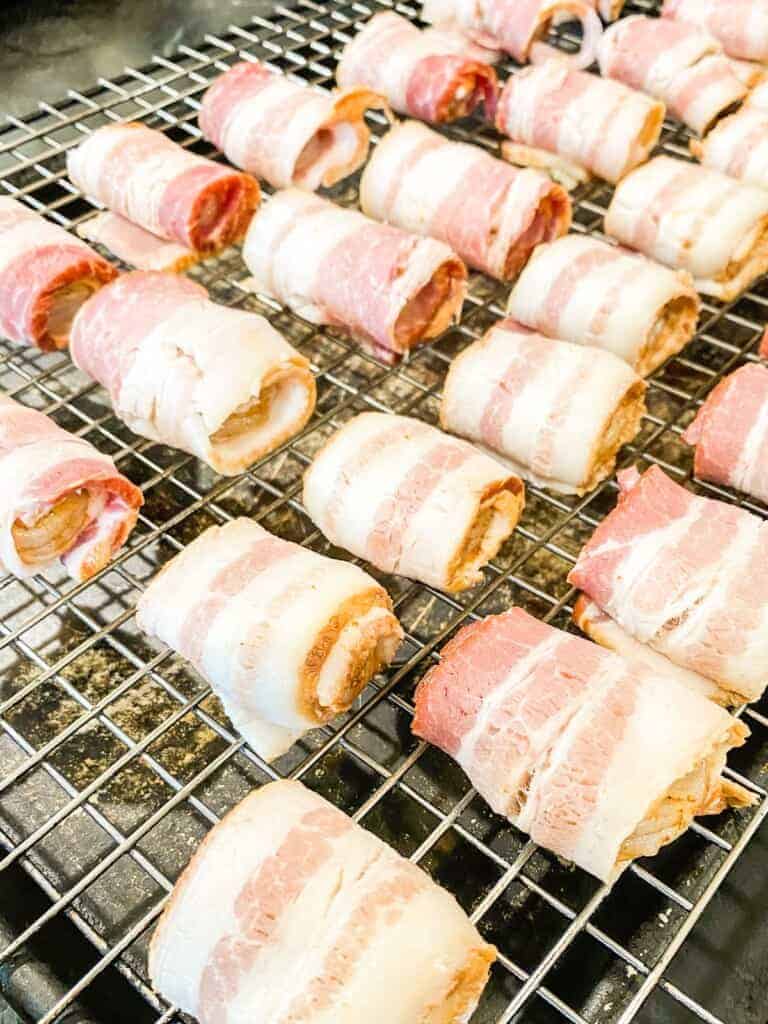 bacon wrapped shrimp on a baking sheet, befor baking.