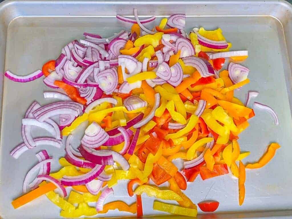 onion and peppers on a sheet pan