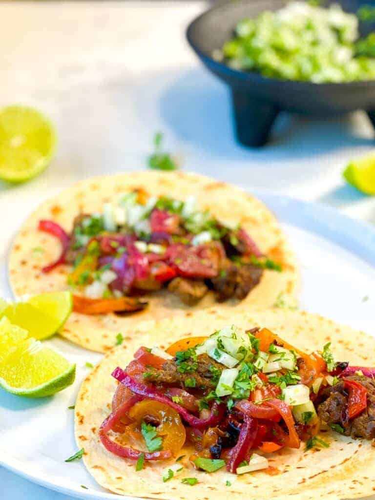 steak fajitas with onions and cilantro topping