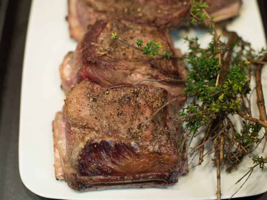 golden brown short ribs resting on a polate