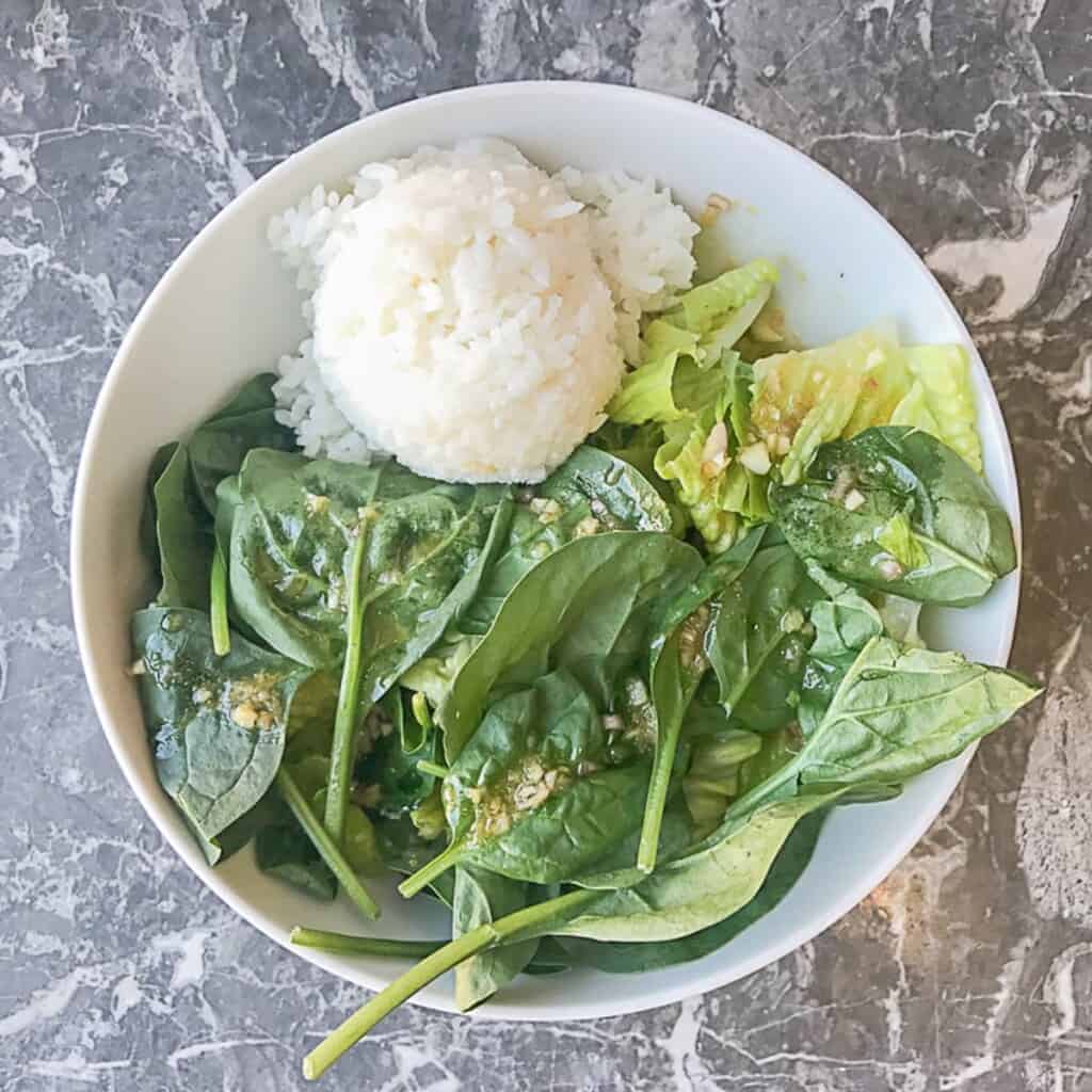 lettuce and spinach with sesame ginger dressing and a scoop of sushi rice