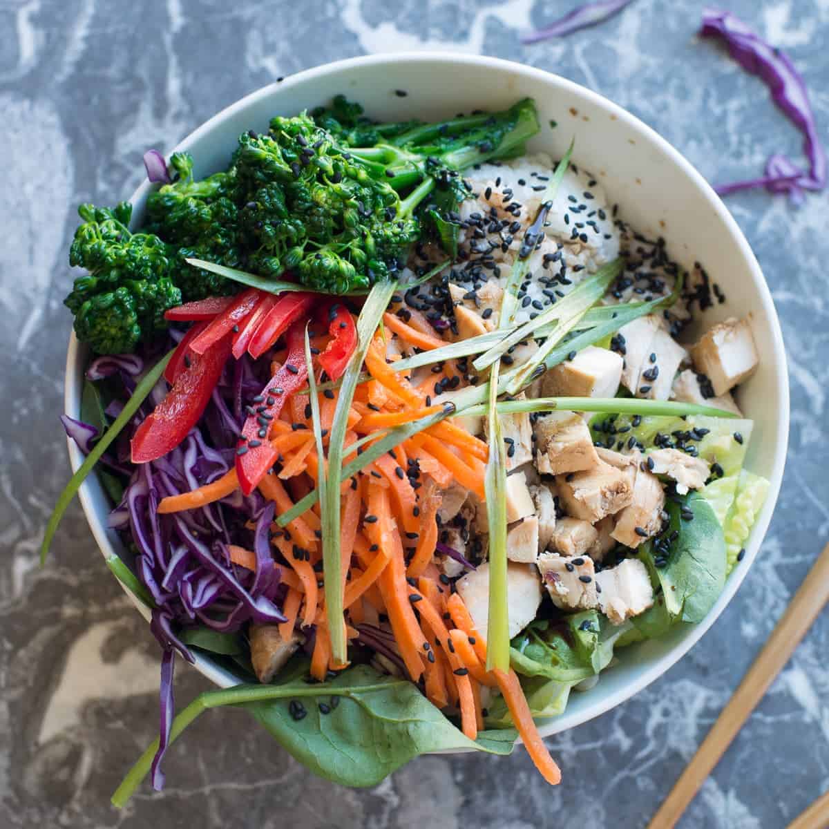 teriyaki chicken meal prep bowl with fresh crunchy veggies and sesame ginger dressing