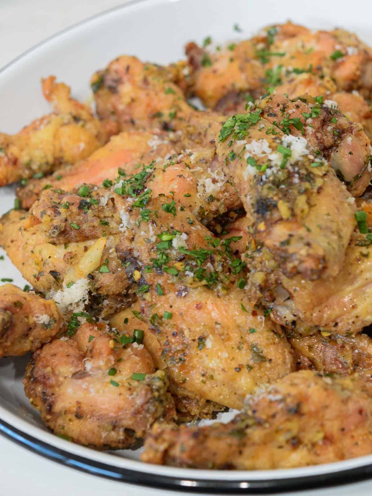 a huge plate of garlic parmesan wings