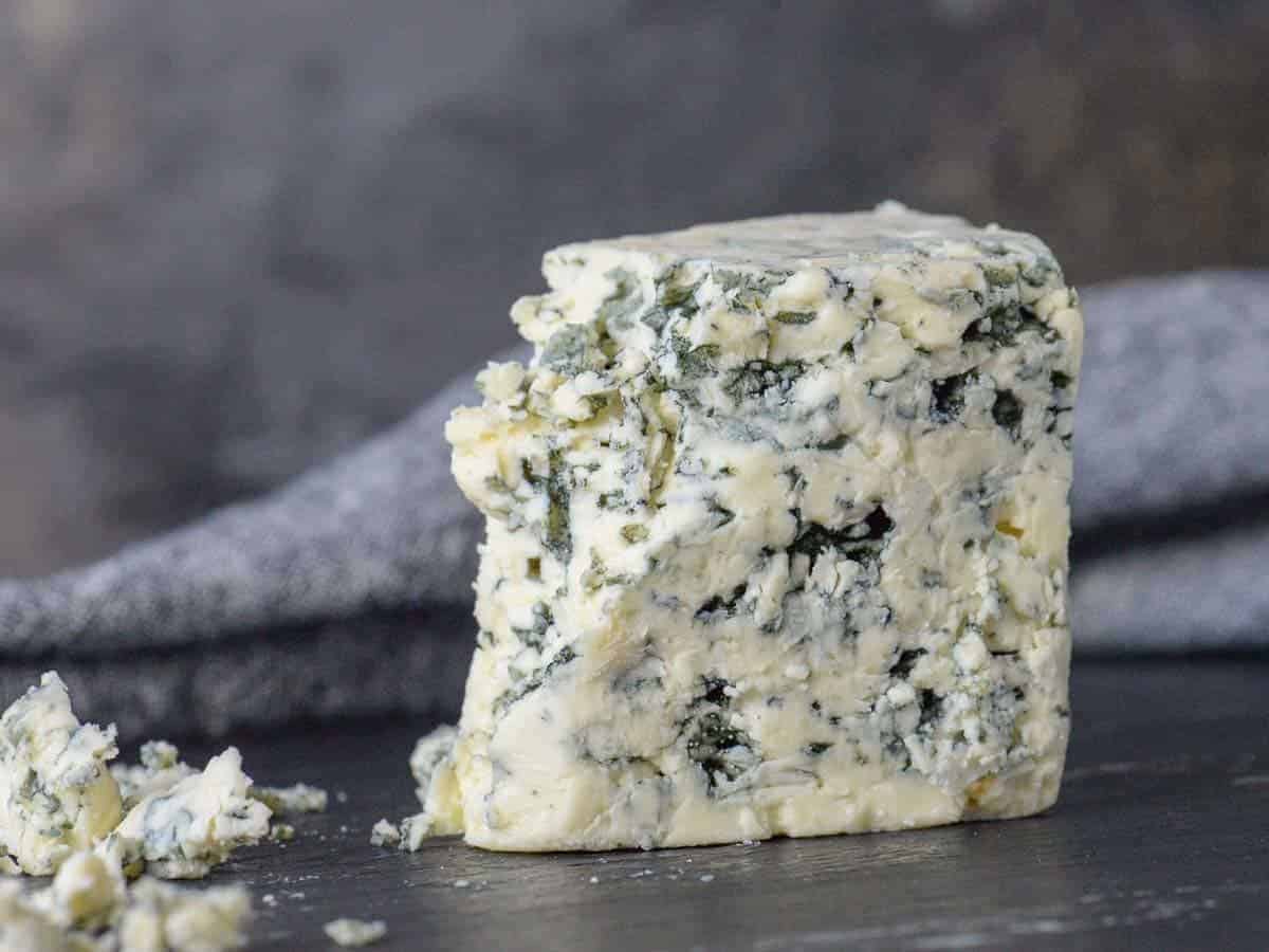 Wedge of castello blue blue cheese on a cheese board