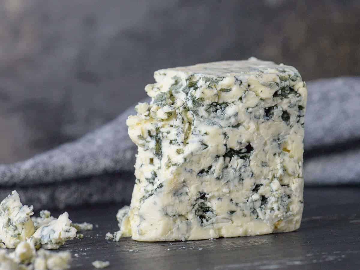 Wedge of castello blue blue cheese on a cheese board
