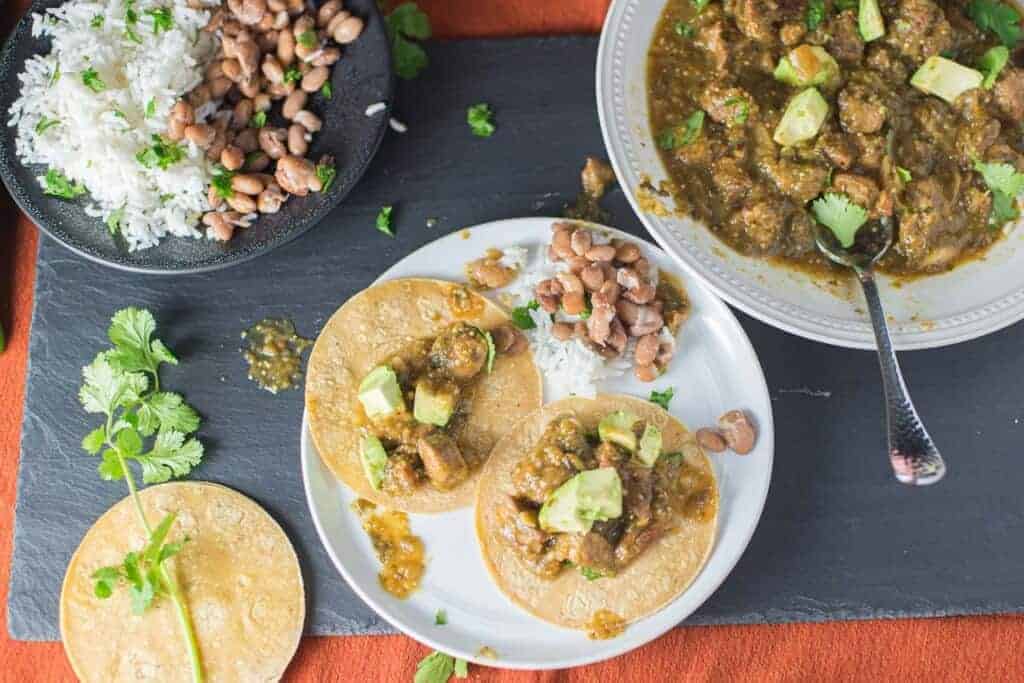 chili verde tacos served with rice and beans and or course corn tortillas