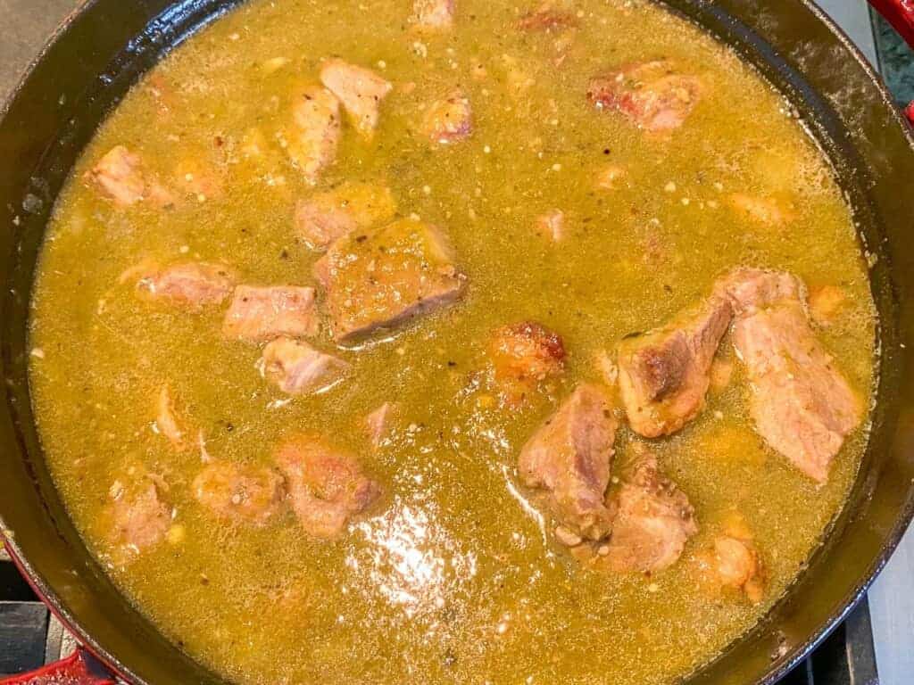 chili verde in a stuab dutch oven cooking on the stovetop
